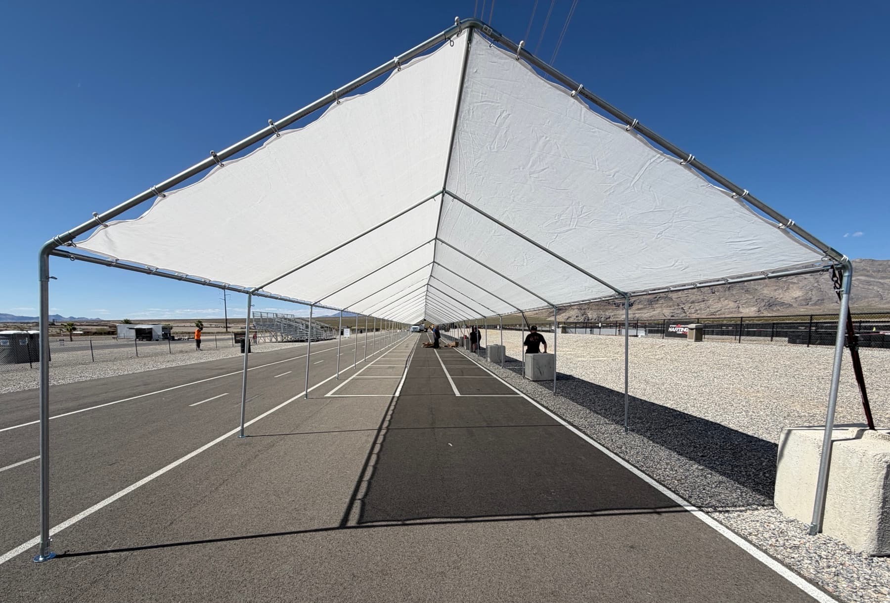 Commercial canopy systems used for motorsports pit lane shade and outdoor staging